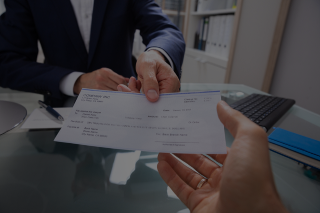 Client receiving a settlement check from their attorney.