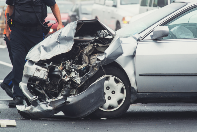 Police officer at the site of a car accident.