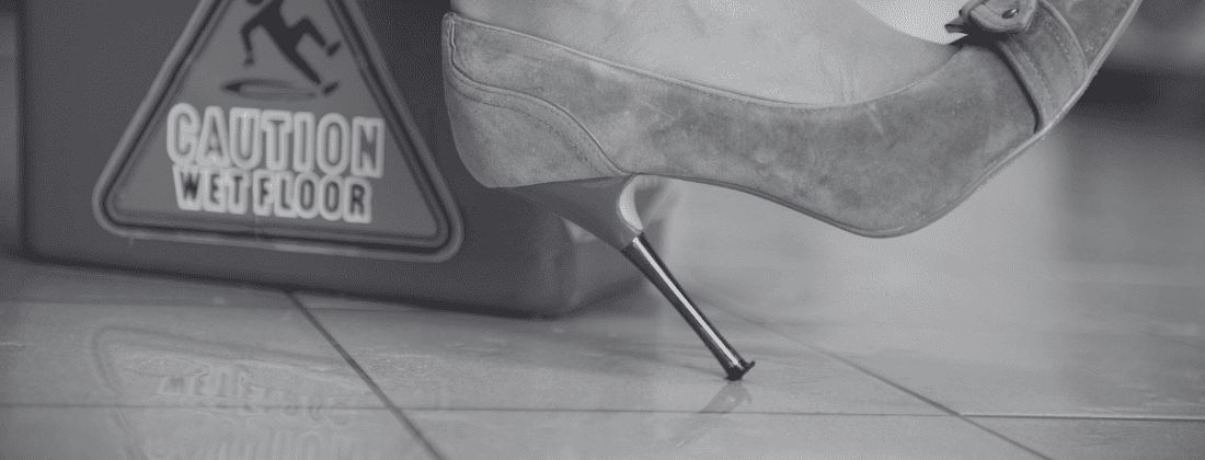 high heels in a wet floor- banner for could my footwear choices affect slip and fall liability