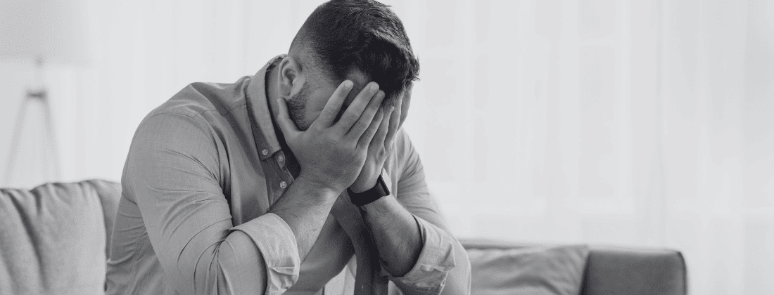 photo of man experiencing pain and suffering