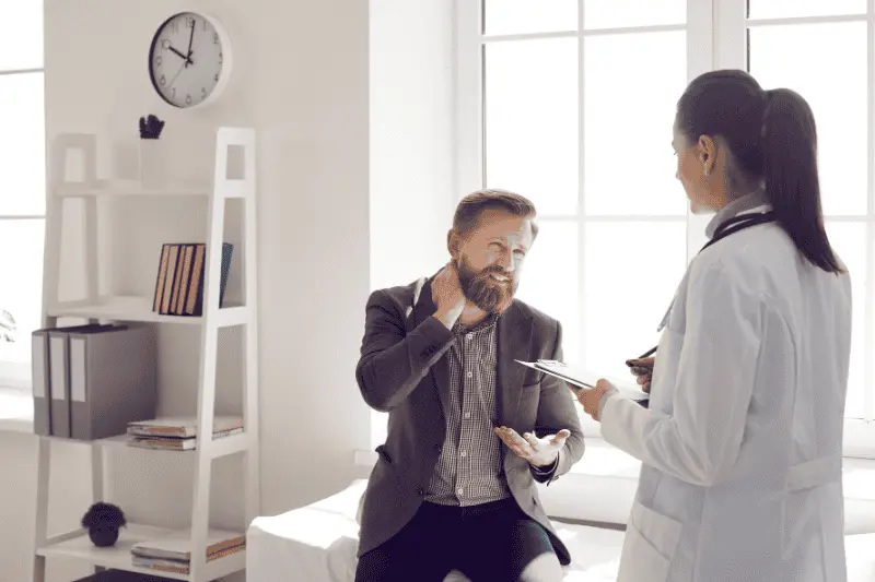 man expressing pain to a doctor