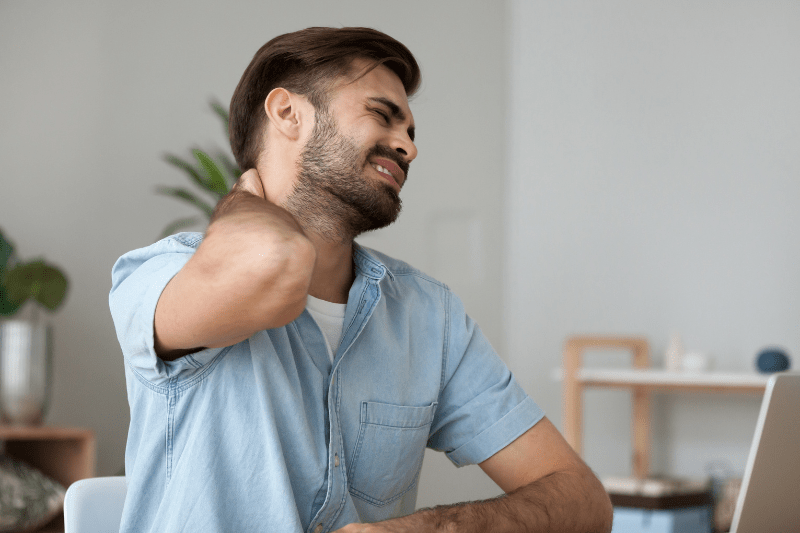 individual with neck pain struggling to sit