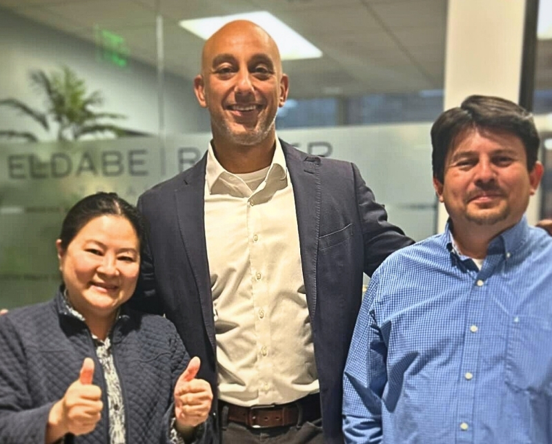 Photo of attorney Edmond El Dabe and happy clients at El Dabe Ritter Trial Lawyers' Los Angeles Office.