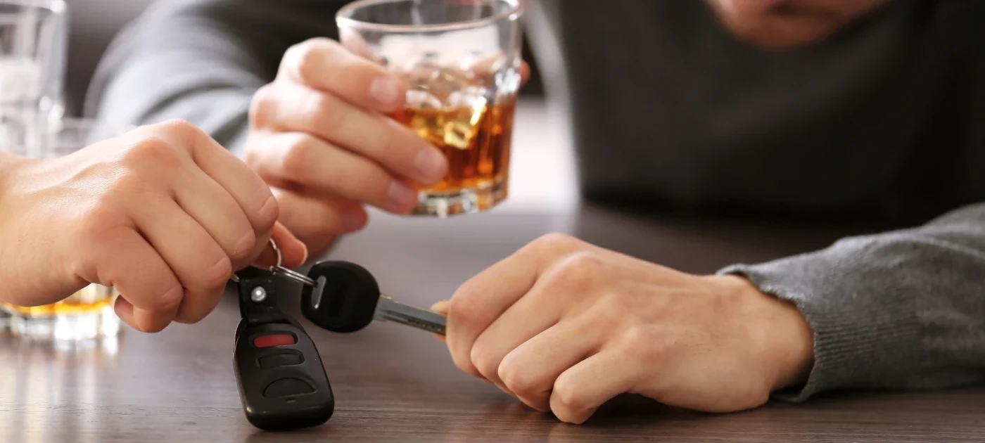 person reaching for keys after having an alcoholic drink