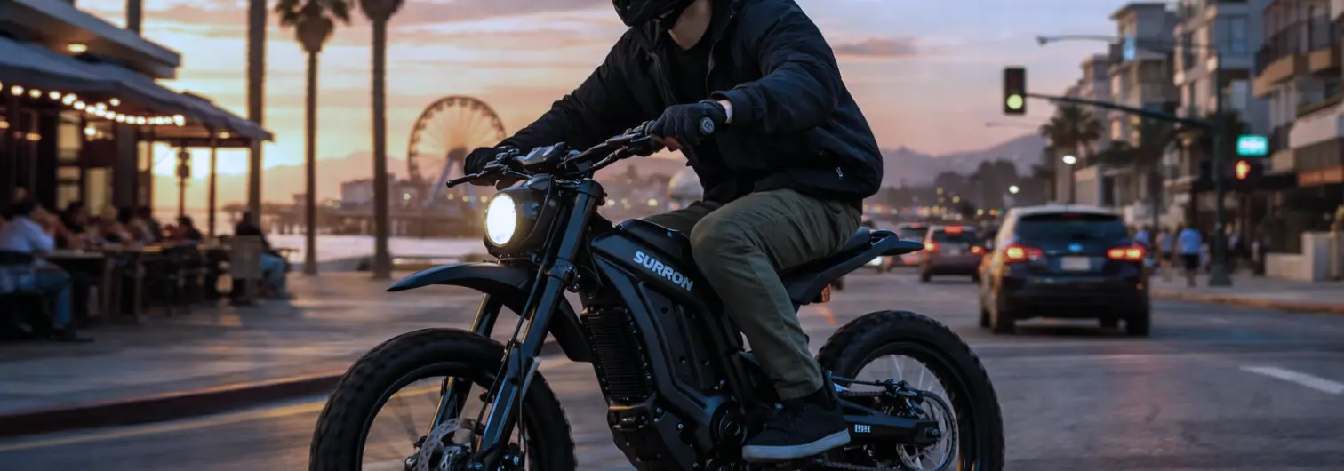 Young person riding a SurRon eMoto in a California coastal city.