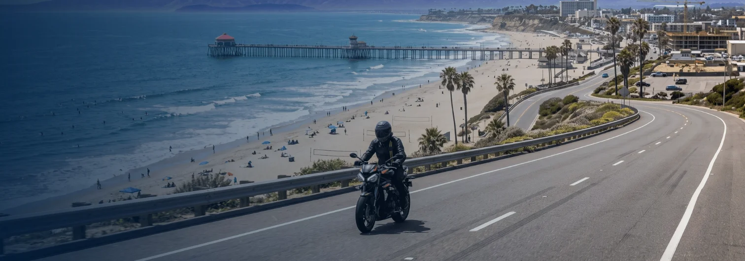 Motorcycle rider traveling southbound on Pacific Coast Highway with the Huntington Beach coastline visible