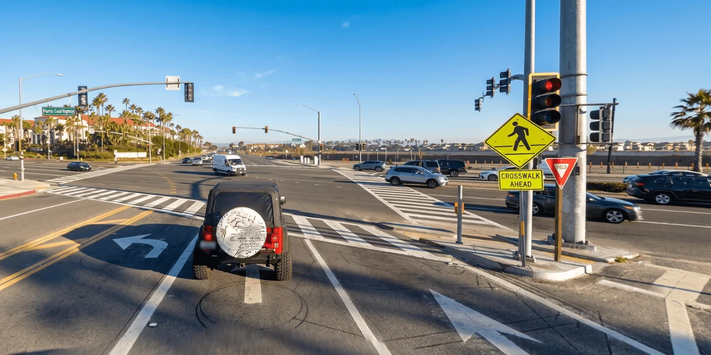 Street-level view of a cross-traffic intersection on Beach Boulevard in Huntington Beach